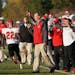 Elk River running back Rahim Avery (22) and the sideline celebrated after Rogers turned the ball over on downs in the fourth quarter.