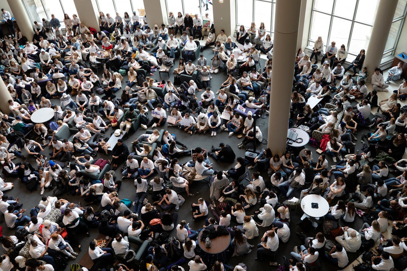 A crowd of students, faculty and staff sits silently in the Anderson Student Center in protest of a racist incident on campus. BESA, the Black Empowerment Student Alliance, organized the event and asked attendees to wear white to "symbolize the current demographic at St. Thomas." The event took place on October 25, 2018 in St. Paul.