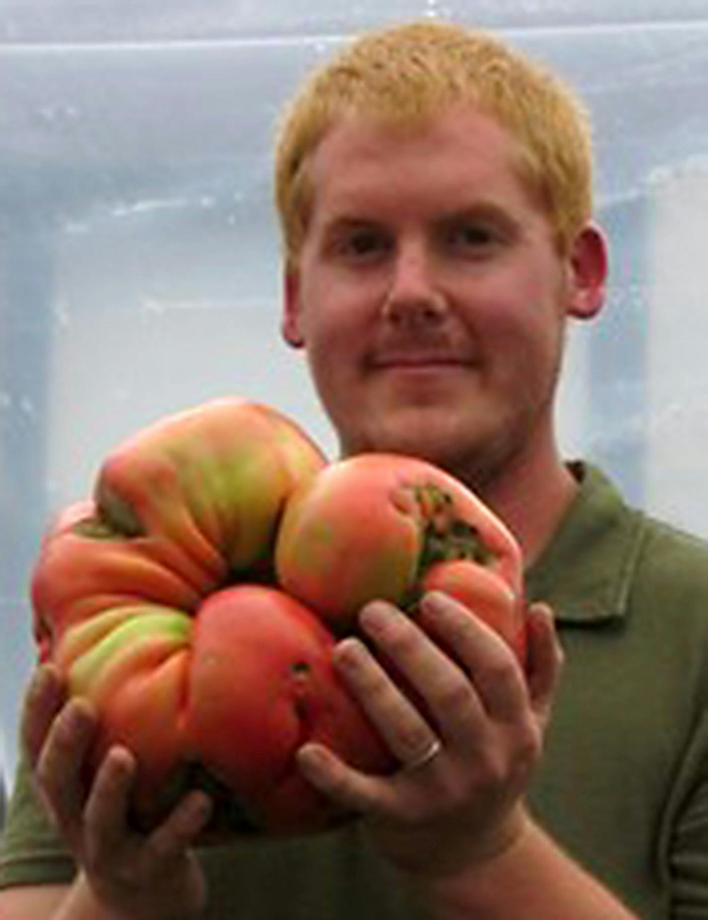 courtesy Dan MacCoy. Dan MaCoy with his 8.41 pound tomato.