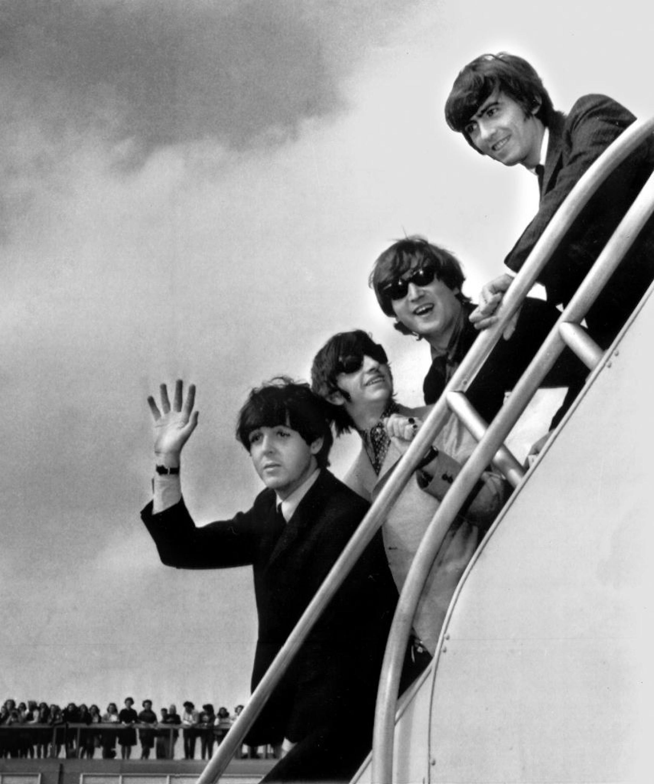 FILE - In this 1964 file photo, The Beatles, from left, Paul McCartney, Ringo Starr, John Lennon and George Harrison board a plane for England in New York. Recently discovered footage of the Fab Four's first full-length concert is the subject of a new documentary, �The Beatles: The Lost Concert� and it includes their entire first full-length concert in the United States. The film's World Premiere is scheduled at New York's Ziegfield Theatre on May 6 with two screenings planned.