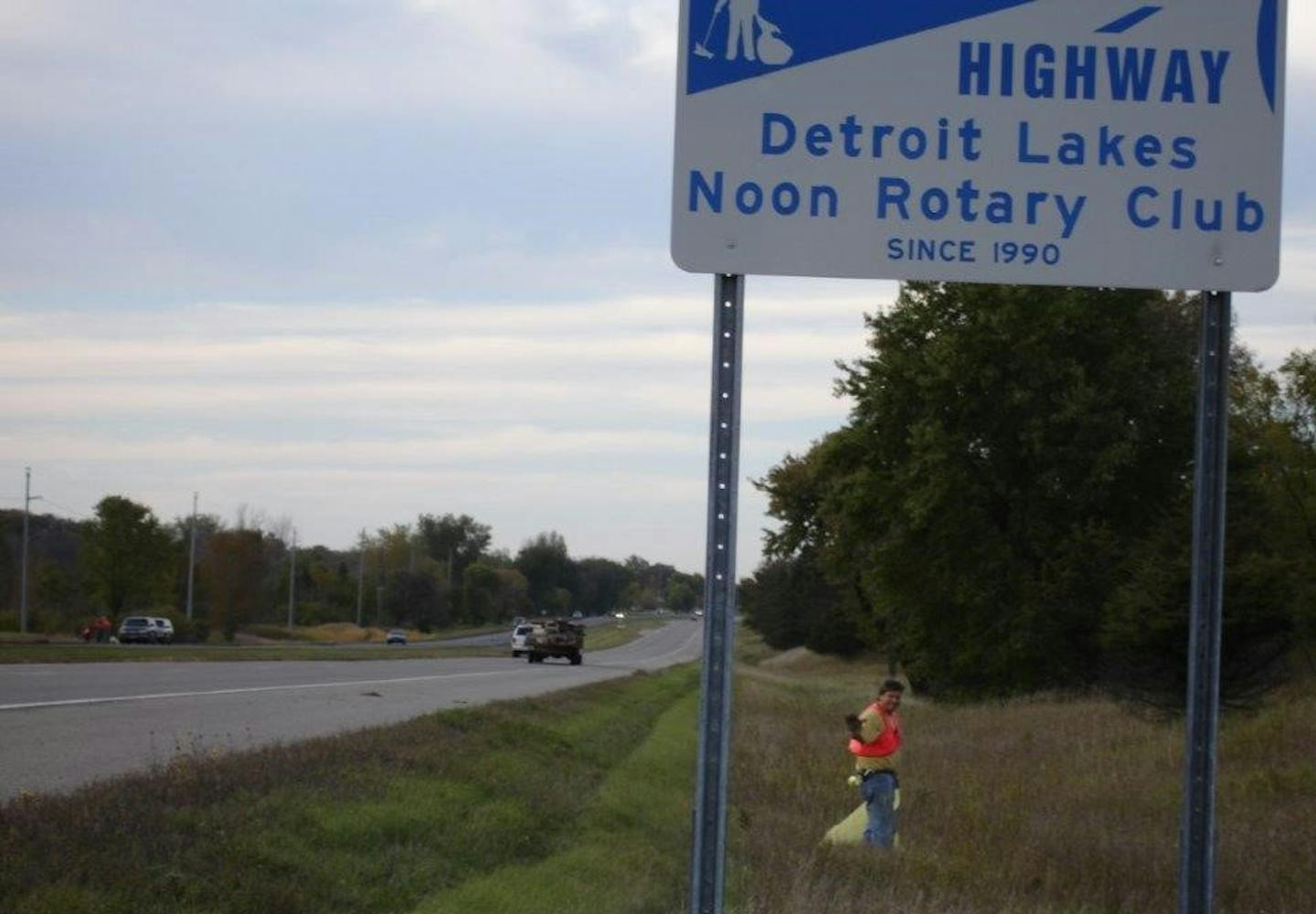 A member of the Detroit Lakes Noon Rotary Club picks up trash along Hwy. 10.