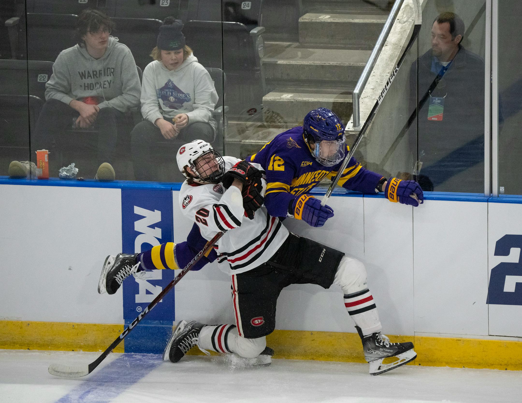 St. Cloud State Huskies forward Jack Rogers (20) pinned Minnesota State Mavericks forward Josh Groll (12) against the boards in the first period.