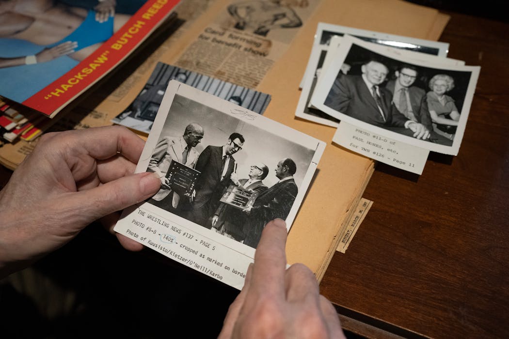 Norm Kietzer looks over old photos and memorabilia.
