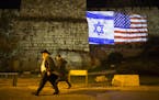 The Israeli and American flags are projected on the wall of the Old City of Jerusalem, Dec. 6, 2017. During a speech in Washington on Wednesday, Presi