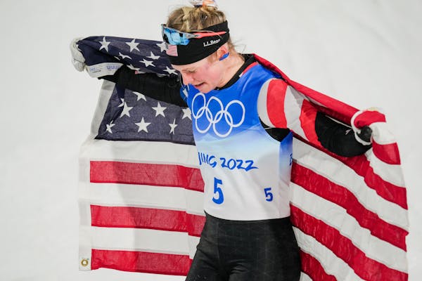 Jessie Diggins of the United States celebrates winning the bronze media in women's sprint free cross-country skiing at the 2022 Winter Olympics in Zha