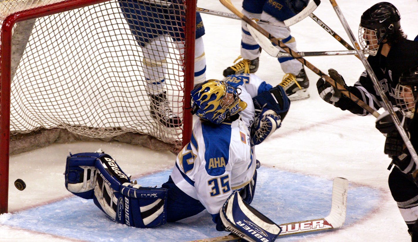 St. Paul - AA Hockey boys semi-final state tourney - Roseville vs. Academy of Holy Angels
IN THIS PHOTO: Roseville's Mark Van Guilder, top right, shoots the puck by Academy of Holy Angels goalie Ben Luth #35, to tie the 2nd-period score at 2-2.