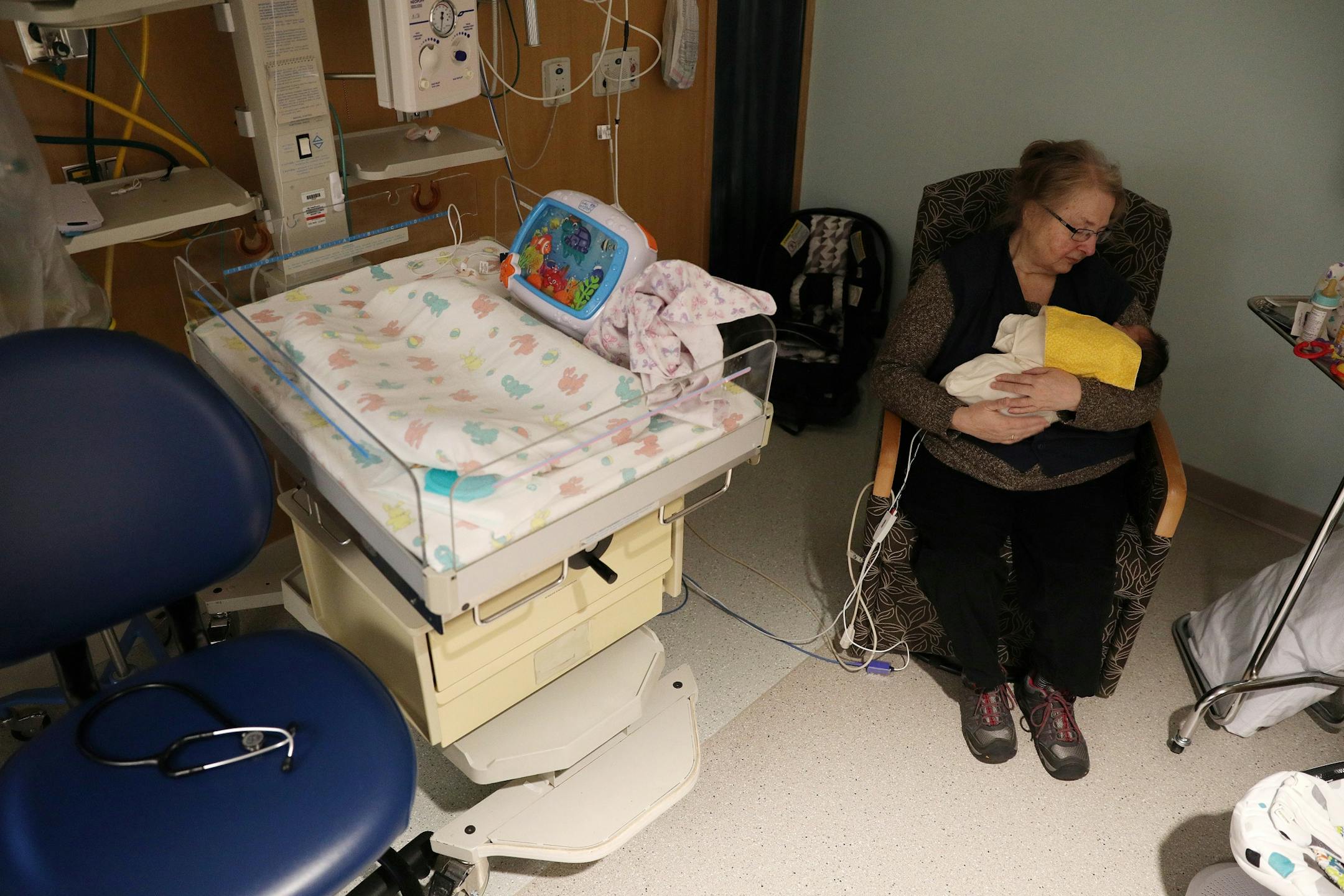 Volunteer Glenda Duhamel rocked a baby with neonatal abstinence syndrome, a condition newborns experience when withdrawing from exposure to narcotics in utero, in the special care nursery at the Sanford Bemidji Medical Center.