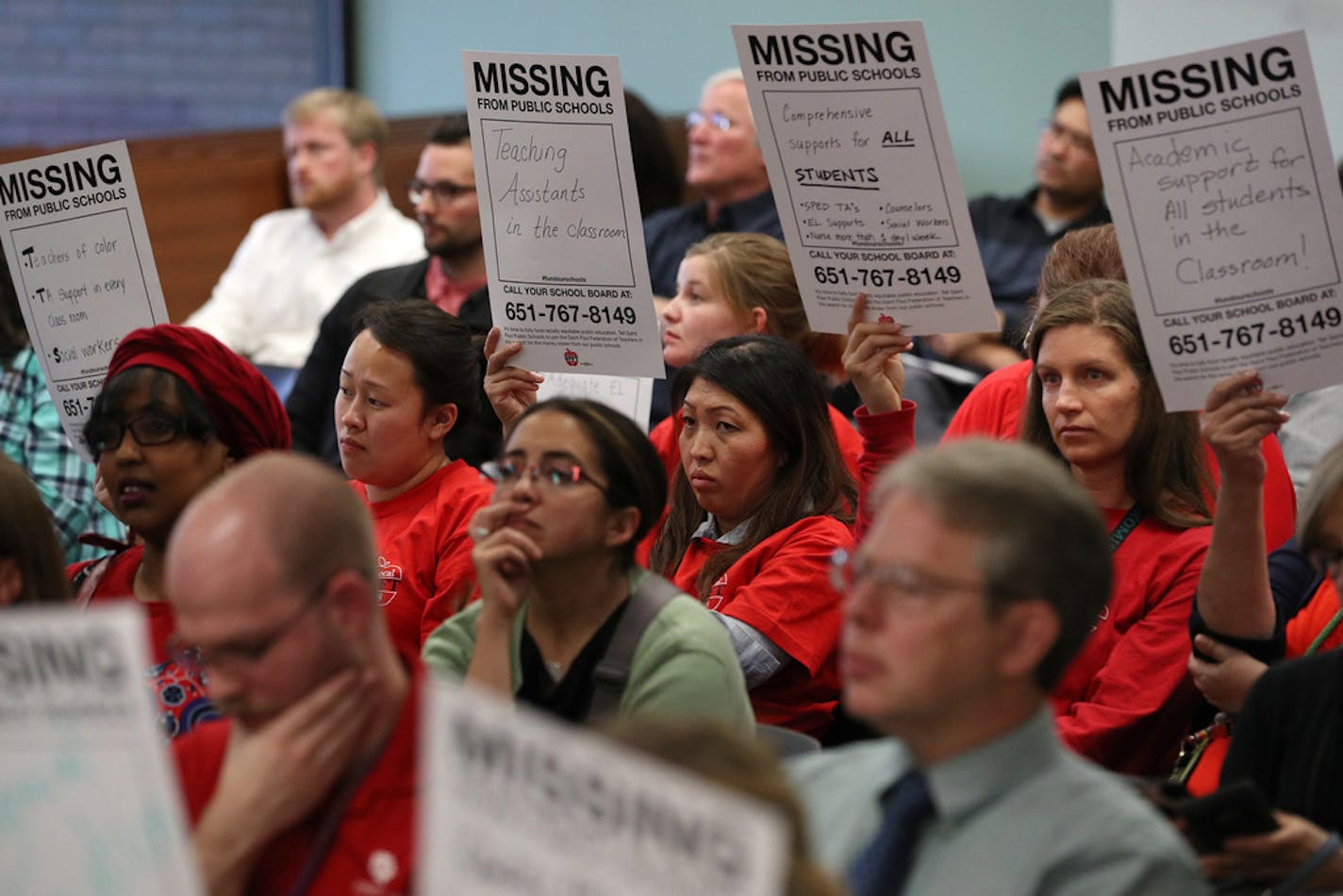 Members of the St. Paul Federation of Teachers wore their signature red shirts and held signs during a public comment period in October 2017.