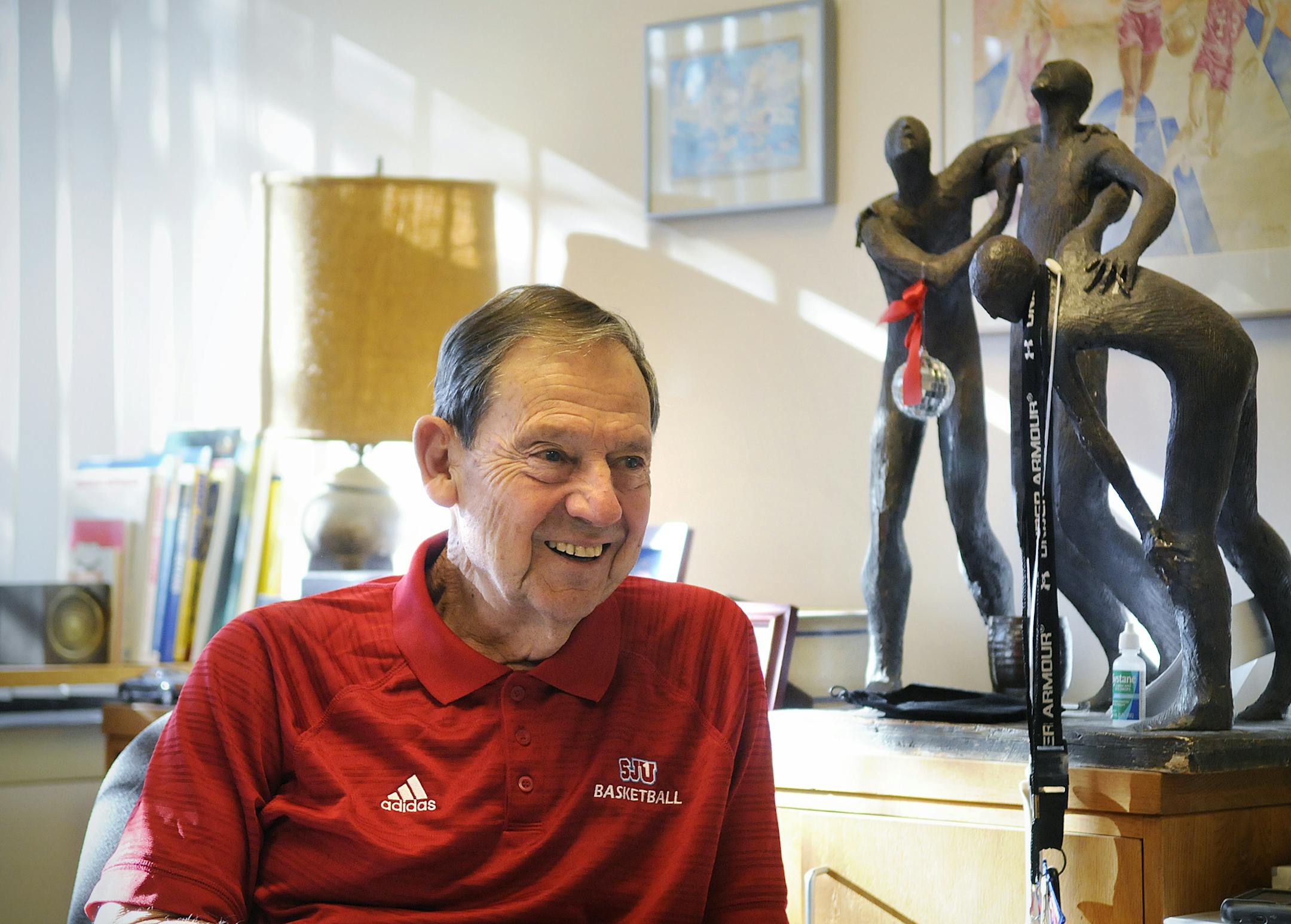 In this Tuesday, March 17, 2015 photo, Jim Smith smiles while talking about his 51 seasons as head basketball coach, in his office at St. John's University in Collegeville, Minn. Smith has announced his retirement after a career that has included 786 victories, making him the winningest college basketball coach at any level in Minnesota history. (AP Photo/The St. Cloud Times, Dave Schwarz)