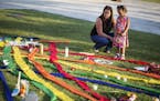 Rhonda Rodeffer, left, and her daughter Kennedy, 4, visit a makeshift memorial for the victims of a mass shooting at the Pulse nightclub Tuesday, June