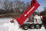 Truckloads of snow, transported from the Highland Ski Jump in Bloomington, were brought to Theodore Wirth Park in preparation for hosting World Cup cr