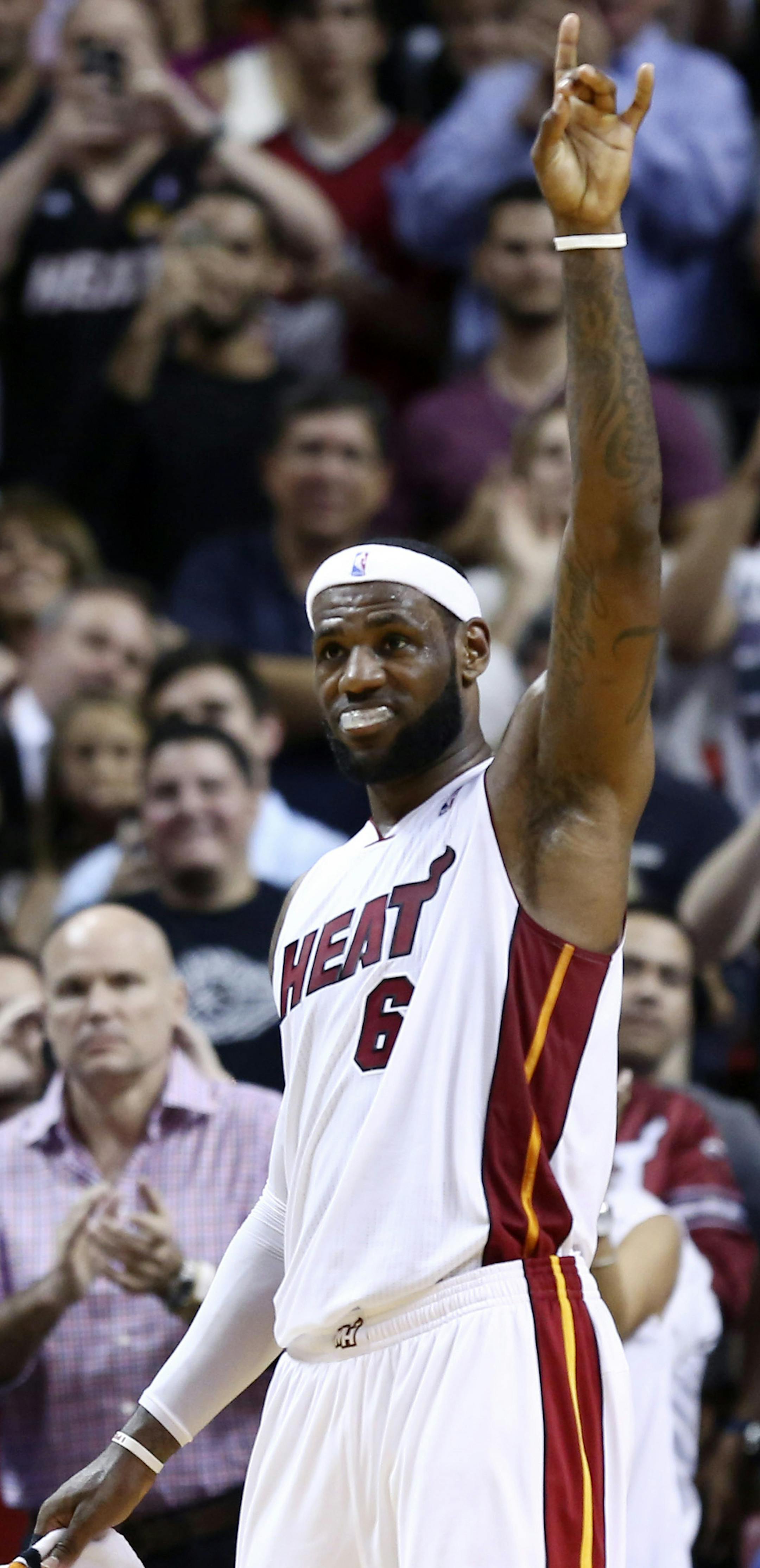 FILE - In this March 3, 2014, file photo, Miami Heat's LeBron James reacts to the crowd after setting a team record of 61 points during the second half of an NBA basketball game against the Charlotte Bobcats in Miami. (AP Photo/J Pat Carter, File)