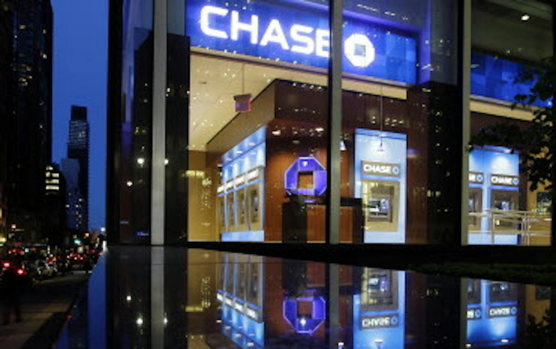 Automobiles pass a JP Morgan Chase building Thursday, May 10, 2012, in New York. JPMorgan Chase, the largest bank in the United States, said Thursday that it lost $2 billion in the past six weeks in a trading portfolio designed to hedge against risks the company takes with its own money. The company's stock plunged almost 7 percent in after-hours trading after the loss was announced. Other bank stocks, including Citigroup and Bank of America, suffered heavy losses as well. (AP Photo/Frank Frankl