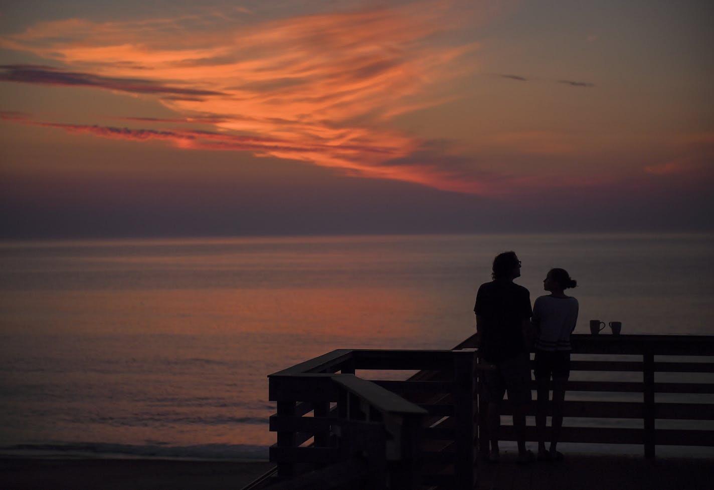 A father and his daughter waited for the first glimpse of the sun at Nauset Light beach in Eastham, Mass.