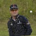 Zach Johnson of the US watches his ball after chipping out of the bunker on the 8th hole during the second round of the British Open Golf Championship