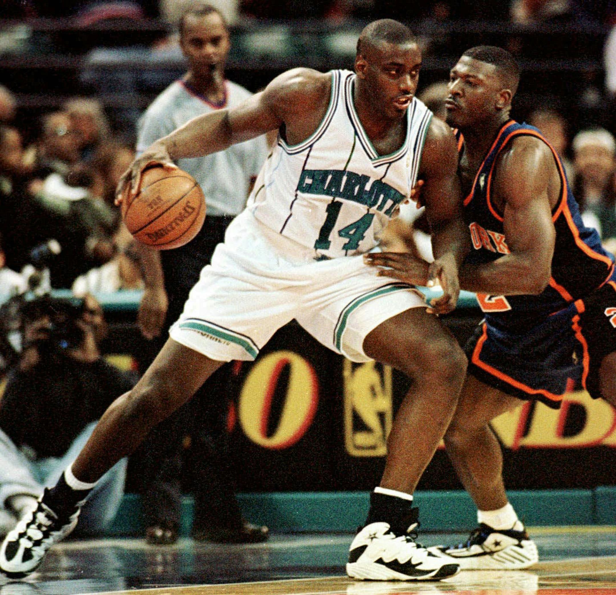 FILE - In this Nov. 20, 1996 file photo, Charlotte Hornets forward Anthony Mason, left, leans in on New York Knicks forward Larry Johnson during first quarter of an NBA basketball game in Charlotte, N.C. The New York Knicks spokesman Jonathan Supranowitz confirmed Saturday, Feb. 28, 2015 that Mason, a rugged power forward who was a defensive force for several NBA teams in the 1990s, has died. He was 48. (AP Photo/Peter A. Harris) ORG XMIT: MIN2015022817505151