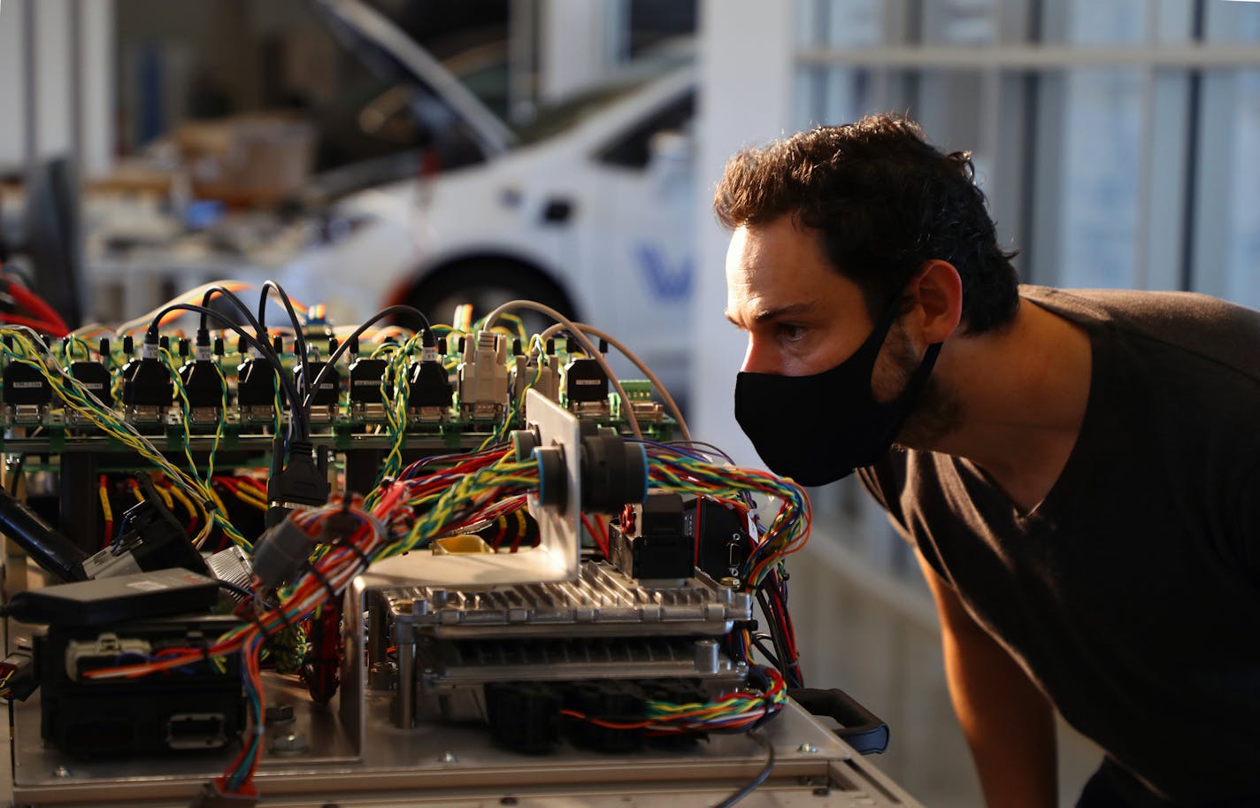 Alan Mond, an engineer at the self-driving car company Voyage, checks components of the "hardware in the loop (HIL)" system in Palo Alto, Calif., on Oct. 16, 2020. The company has arranged for engineers to log on to their home computers for remote access to the HIL to run tests remotely. (Jim Wilson/The New York Times) ORG XMIT: XNYT114