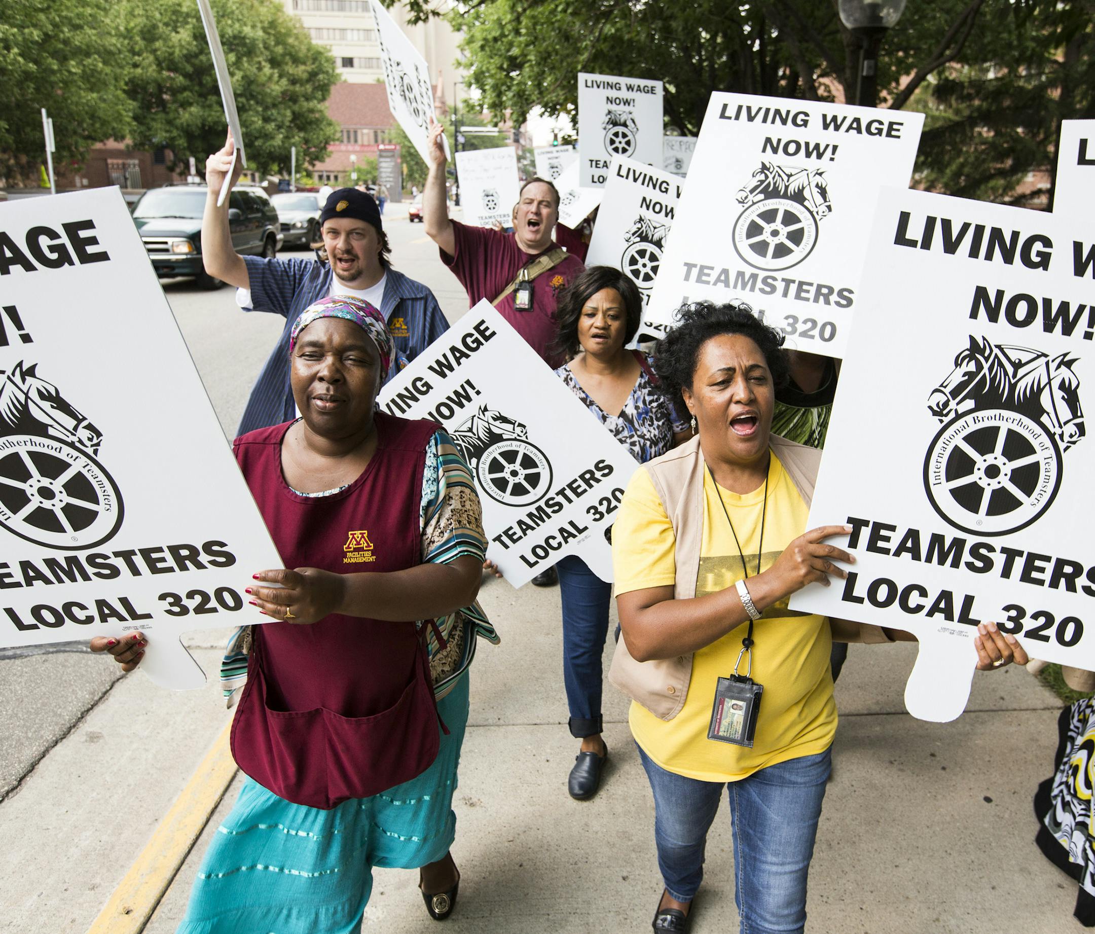 Alice Enoka, left, and Asege Weldgebriel, both custodial workers at the University of Minnesota, protest with the Teamsters Local 320 for a wage increase on campus on Monday, August 31, 2015. ] LEILA NAVIDI leila.navidi@startribune.com / BACKGROUND INFORMATION: Members of the Teamsters Local 320 who work at University of Minnesota protested on the campus to raise awareness of contract negotiations.