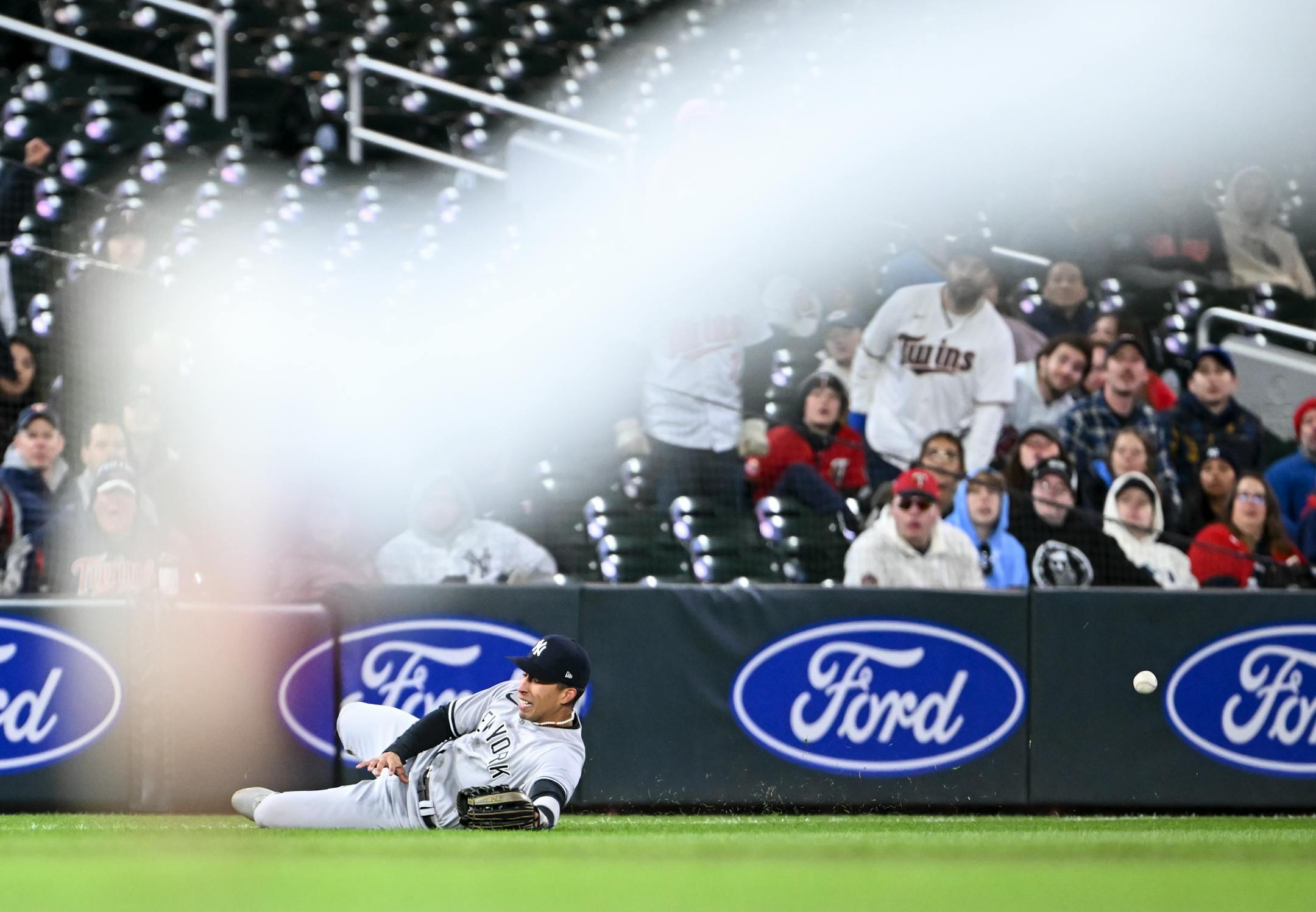 New York Yankees left fielder Oswaldo Cabrera drops a fly ball hit by Minnesota Twins second baseman Jorge Polanco, allowing a run by right fielder Max Kepler in the bottom of the 6th inning Monday.