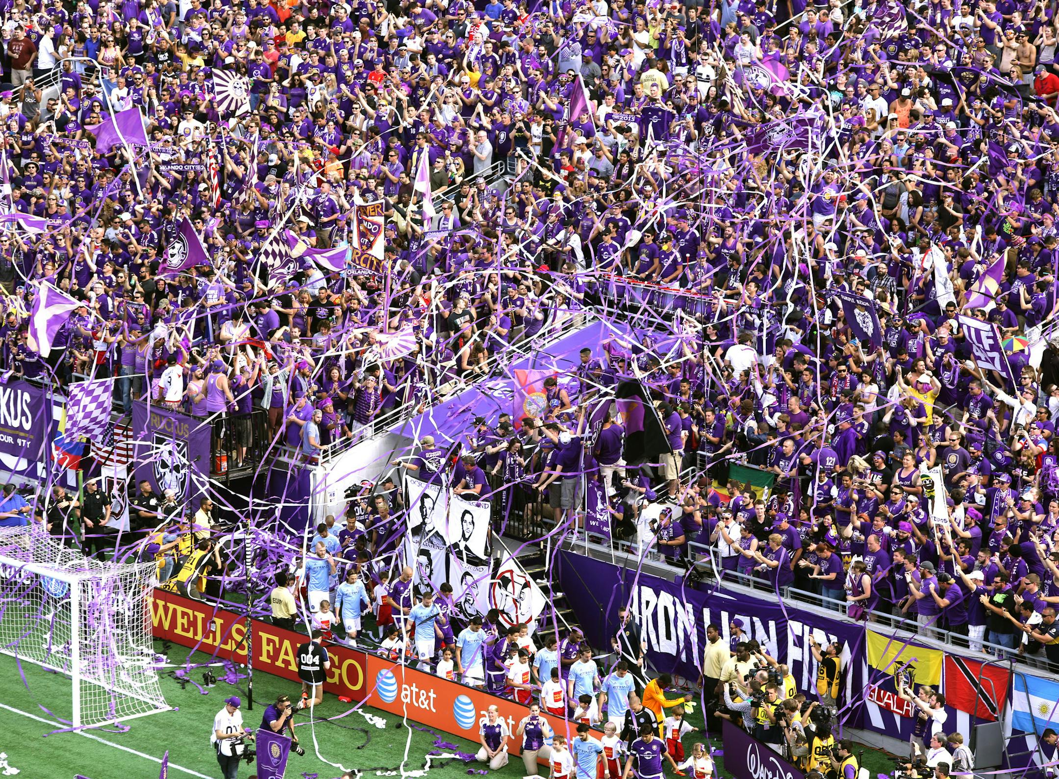 Fans wave flags and cheer during team introductions of the inaugural MLS soccer game between New York City FC and Orlando City, Sunday, March 8, 2015, in Orlando, Fla. Orlando City's Kaka scored in extra time to give the Lions a 1-1 tie in front of an announced crowd of 62,510 at Citrus Bowl Stadium. (AP Photo/Orlando Sentinel, Joe Burbank) ORG XMIT: MIN2015032410554038
