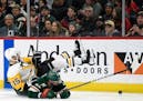 Minnesota Wild's Eric Staal (12) and Pittsburgh Penguins' Riley Sheahan (15) fall while going after the puck during the second period of an NHL hockey