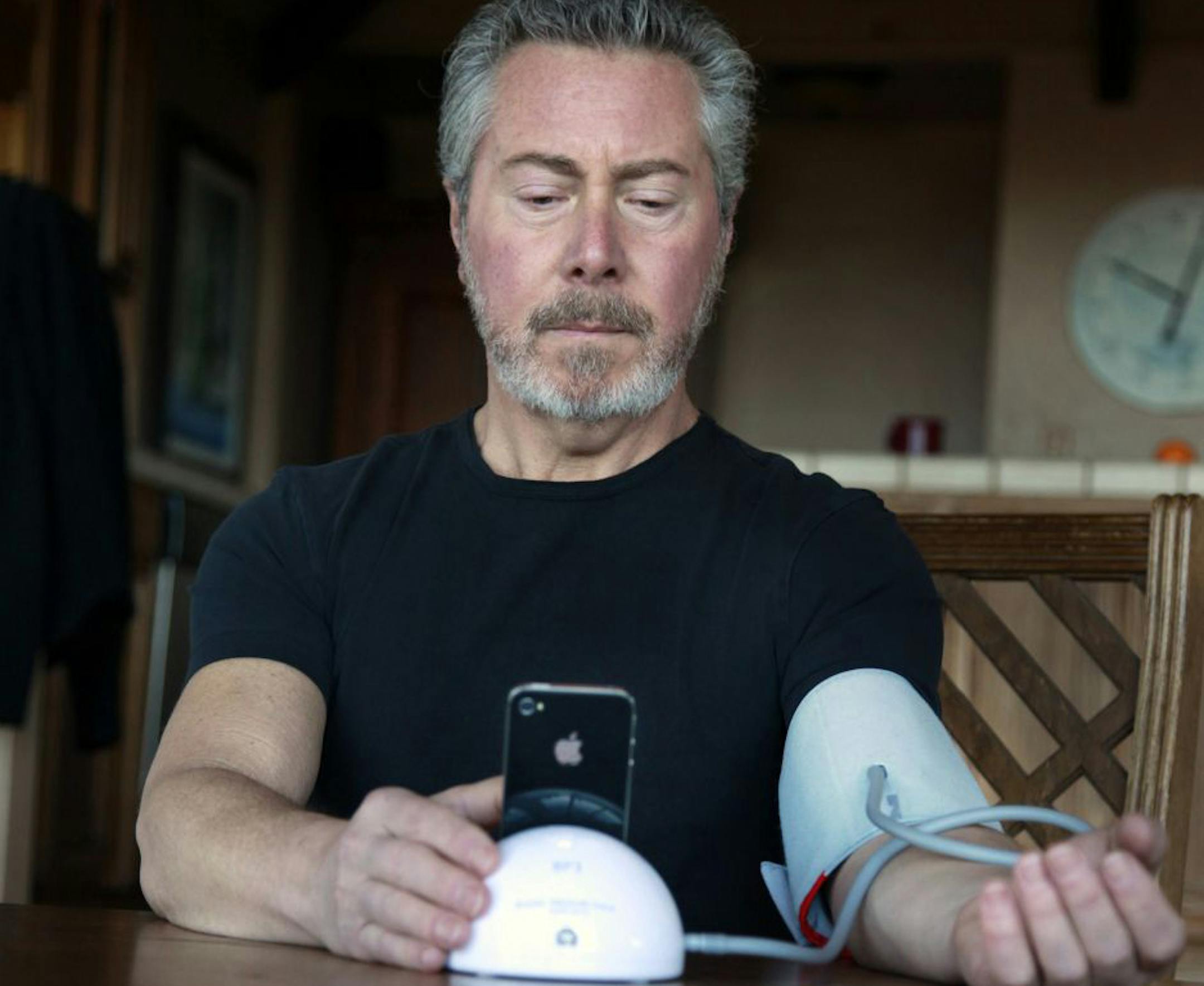 Eric Nagel checked his blood pressure at his home in Los Gatos, Calif. The iHealth device he uses sends data to his iPhone that he can forward to his doctor. With diet, exercise and monitoring, he says, he's been able to lower his blood pressure.