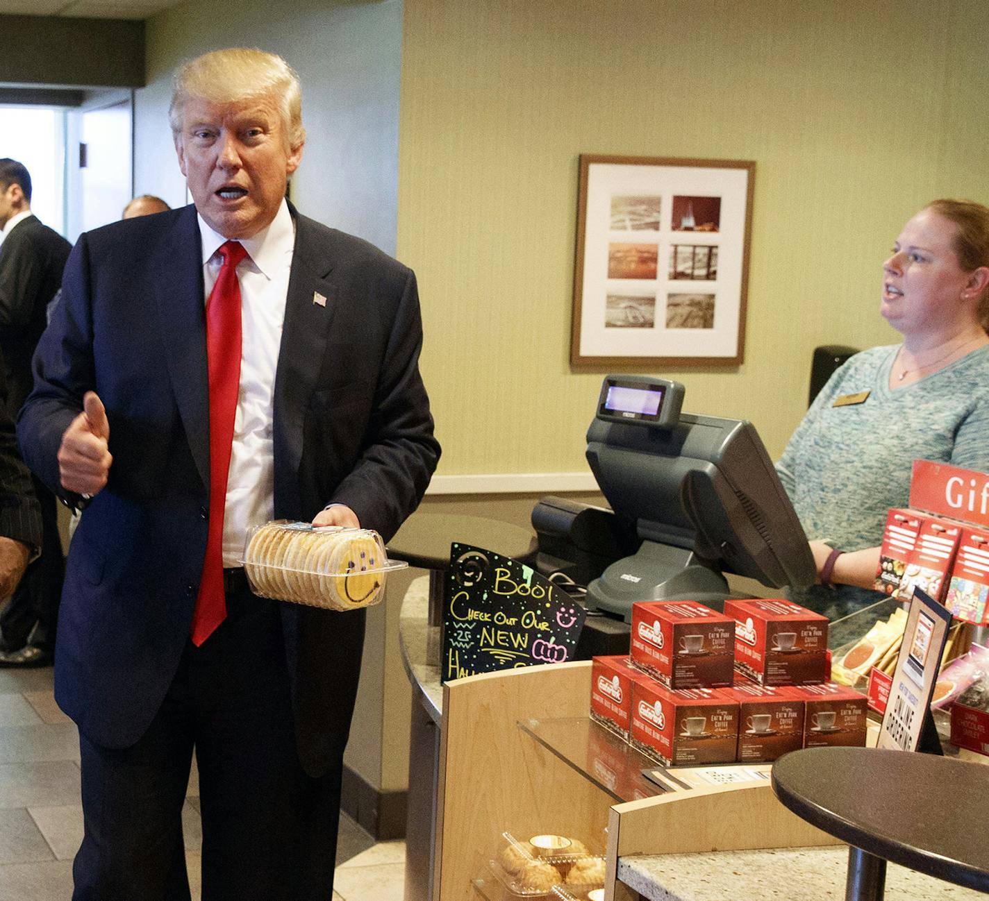 FILE - In this Oct. 10, 2016, file photo, former New York mayor Rudy Giuliani, left, stands with then-Republican presidential candidate Donald Trump as he buys cookies during a visit to Eat'n Park restaurant in Moon Township, Pa. Will President-elect Trump remake school lunches into his fast-food favorites of burgers and fried chicken? Children grumbling about healthier school meal rules championed by first lady Michelle Obama may have reason to cheer Trump's election. The billionaire businessma