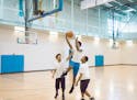 Teens play basketball at a branch of the Greater Twin Cities YMCA. The YMCA is offering free summer memberships to high school students. Signup starts