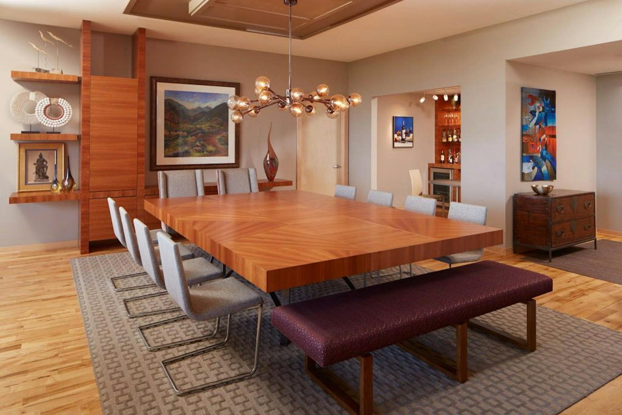 To accommodate family holiday meals, a custom designed dining table has two leaves that expands the width, rather than the length, to form a big square.