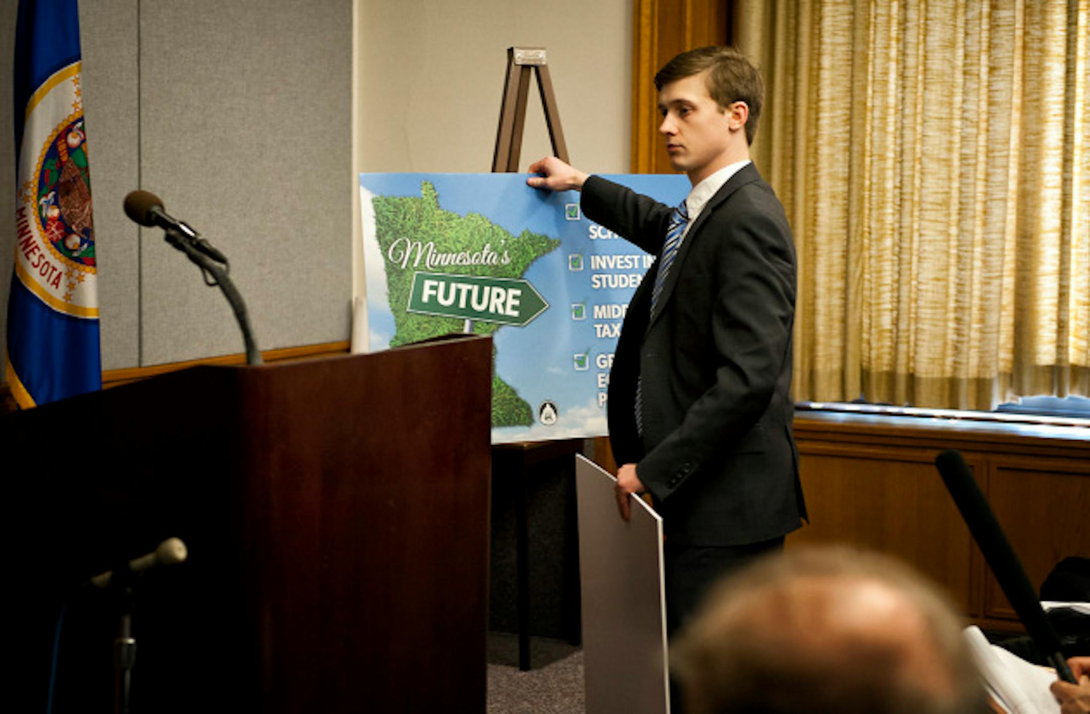 A DFL staffer took down the press conference sign used to illustrate Minnesota's future.  House Democrats want those making more than $500,000 to come up with about $854 million over the next two years, paying back K-12 public schools.   Tuesday, March 19, 2013.   ]   GLEN STUBBE * gstubbe@startribune.com