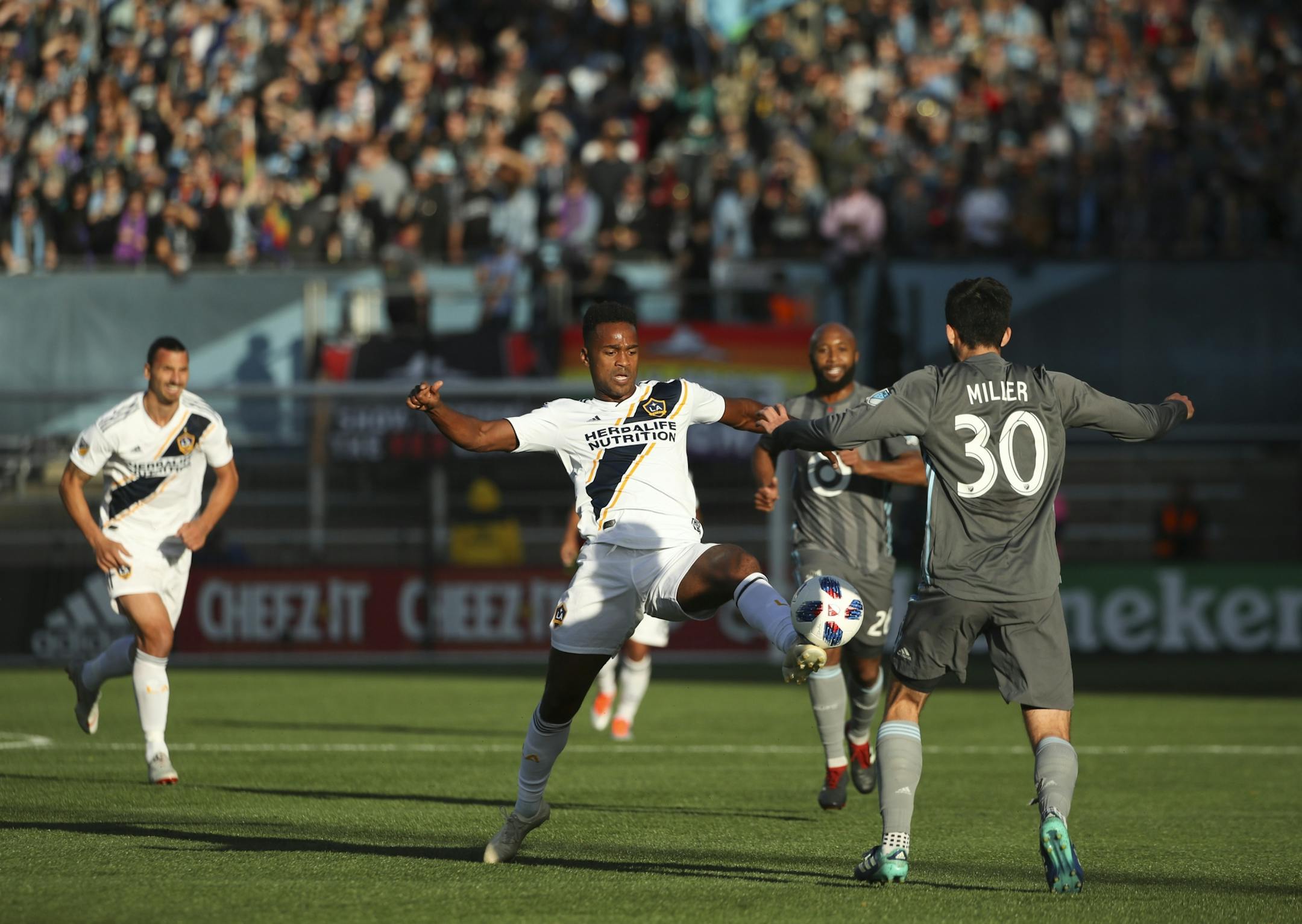 Los Angeles Galaxy forward Ola Kamara (11) directed the ball ahead of Minnesota United defender Eric Miller (30) in the first half.