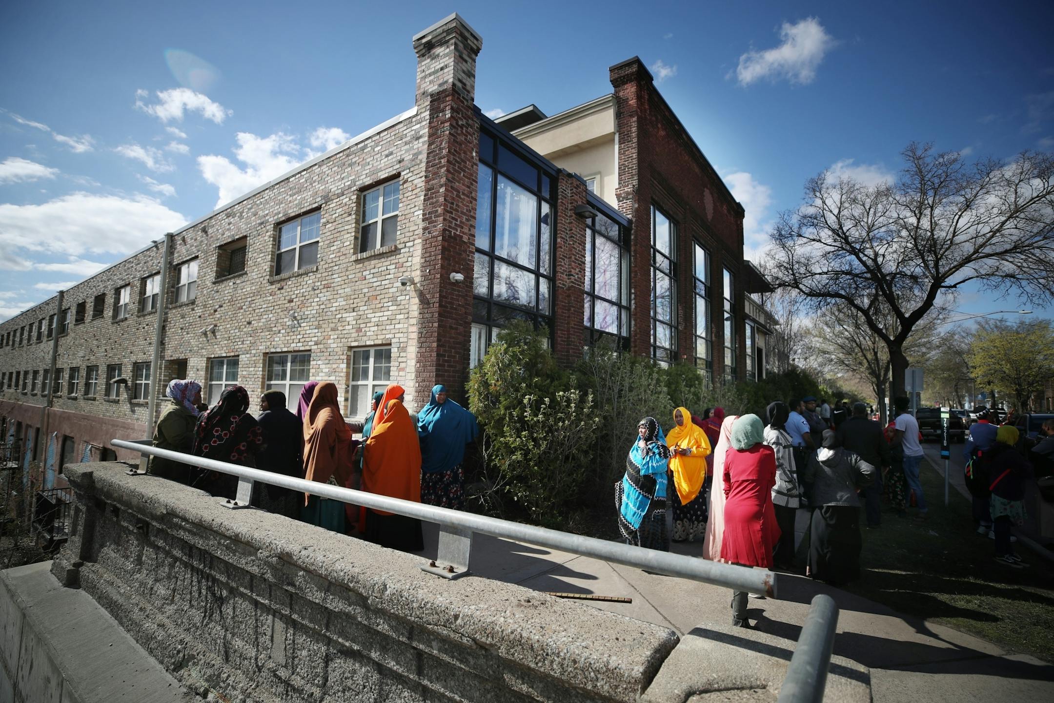Women gathered at the Karmel Village Apartments after two children fell from an apartment building at S. 28th and Pleasant Avenue Thursday May 2, 2019 in Minneapolis, MN.