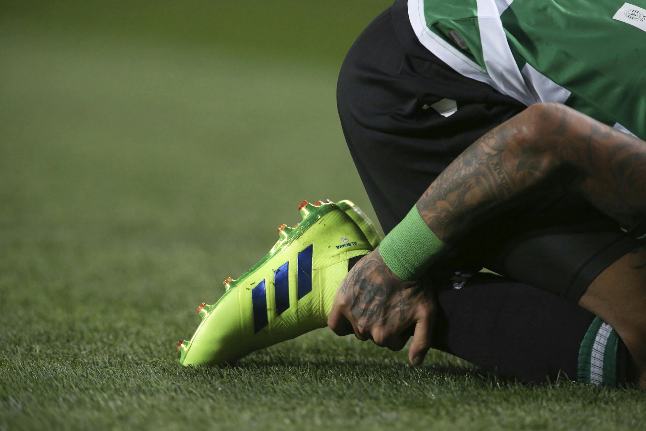 Sporting's Raphinha hold his right ankle after sustaining an injury during the Europa League round of 32, first leg, soccer match between Sporting CP and Villarreal at the Alvalade stadium in Lisbon, Thursday, Feb. 14, 2019. (AP Photo/Armando Franca)