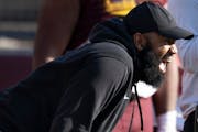 Minnesota Gophers defensive line coach Winston Delattiboudere directs players during practice last spring.