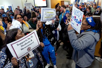 Demonstrators gathered in the hallway outside of a school board meeting for the Stabilize Our Schools by Stabilizing our Workforce Rally sponsored by 