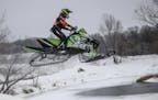 A member of Team Arctic Cat catches big air during a competition at the ERX Motor Park in Elk River in December 2014.