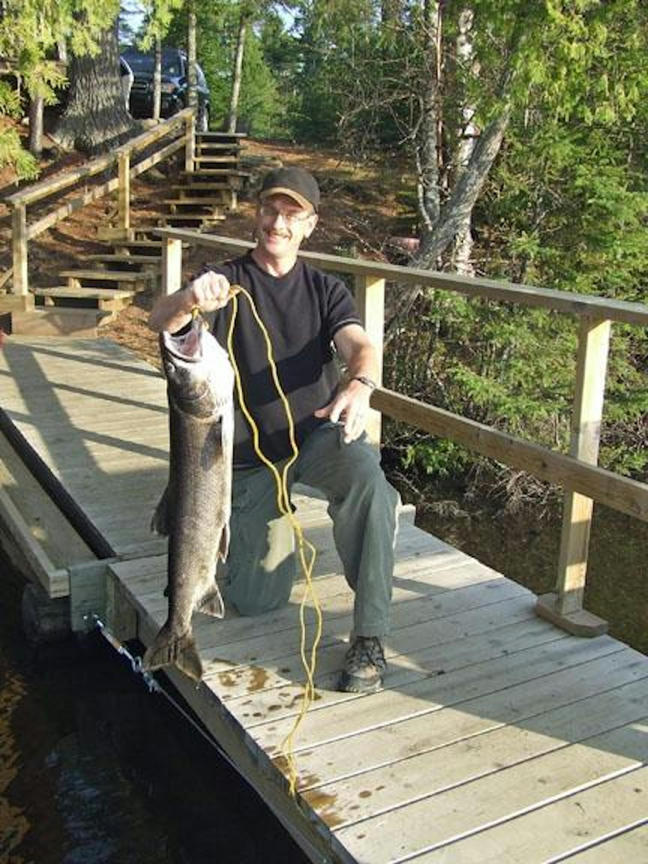 Tom Baumberger and his 14 lb. Lake Trout caught on the dock at Clearwater Lodge.