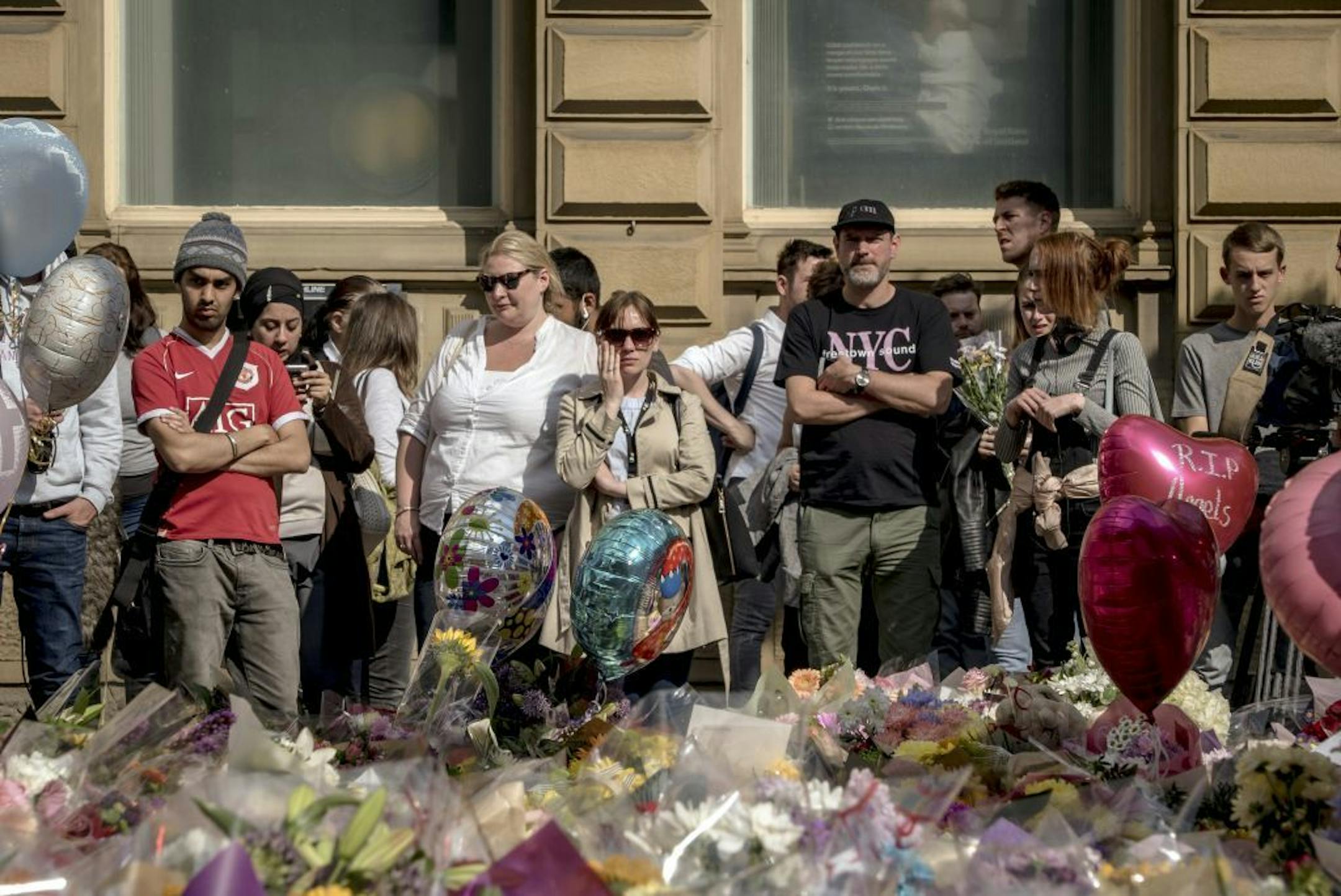 FILE-- Mourners at a vigil to the victims of the Manchester Arena bombing, at the nearby St. Ann�s Square in Manchester, England, May 24, 2017. The bomber, Salman Abedi, is said to have kept up contact with members of Battar al-Libi, the Islamic State unit that trained the commander of the 2015 Paris terror attacks.