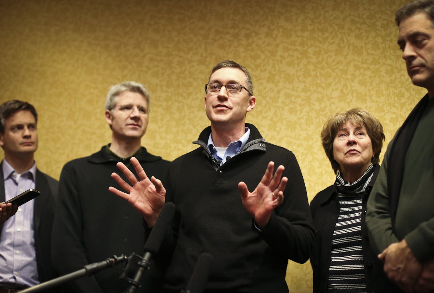 Minnesota Orchestra clarinetist Tim Zavadil spoke about the announcement of a contract agreement with the board bringing the Orchestra back to work February 1. he was flanked by fellow musicians Kevin Watkins, Doug Wright, Marcia Peck and Tony Ross at the Hilton Hotel on Tuesday, January 14, 2014, in Minneapolis, Minn. ] RENEE JONES SCHNEIDER &#x2022; reneejones@startribune.com