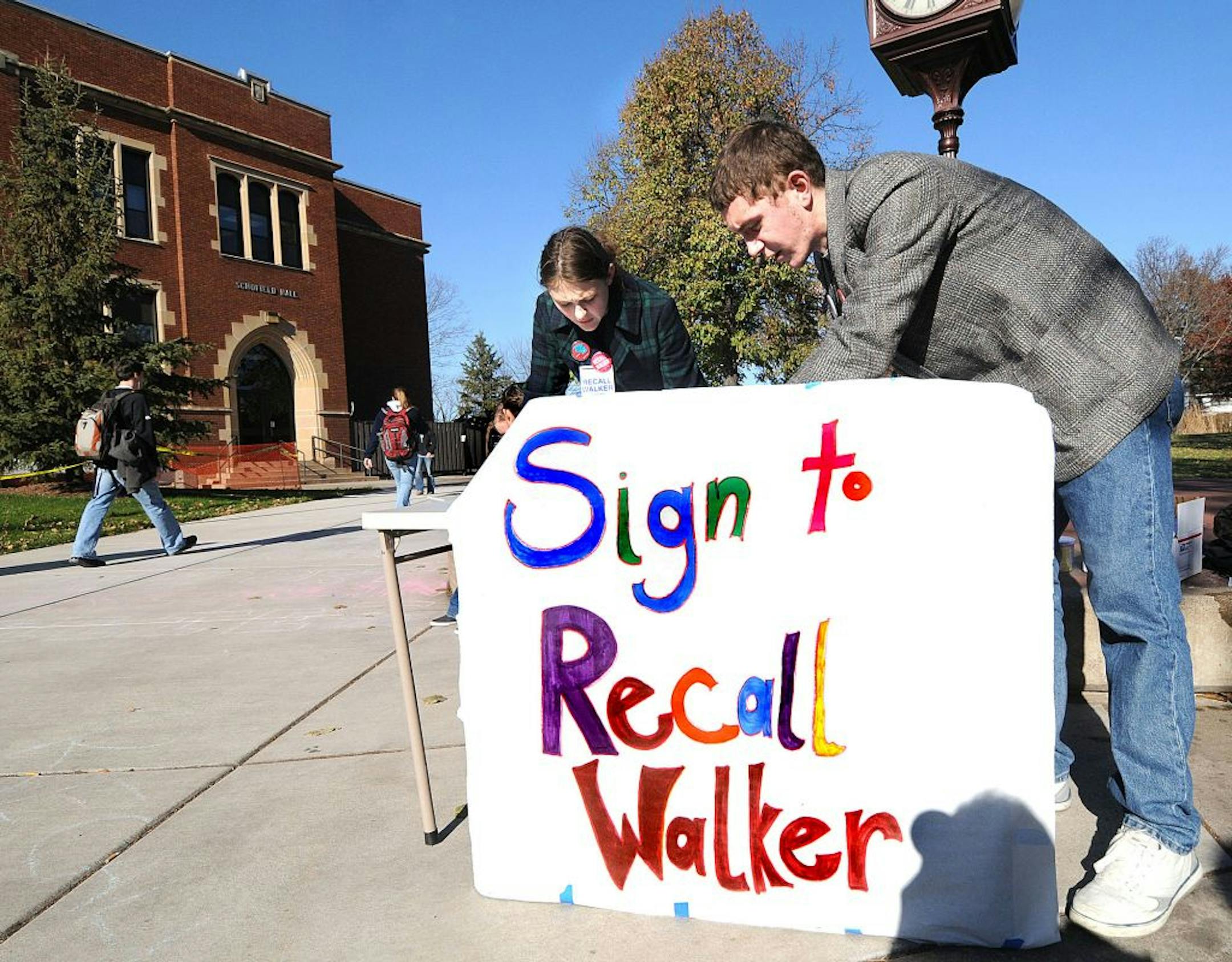 A table is staffed by two unidentified workers Tuesday, Nov. 15, 2011 on the University of Wisconsin-Eau Claire campus mall during the first day of a statewide effort to recall Gov. Scott Walker, in Eau Claire, Wis. Walker opponents must collect more than 540,000 signatures to force a recall election next year.