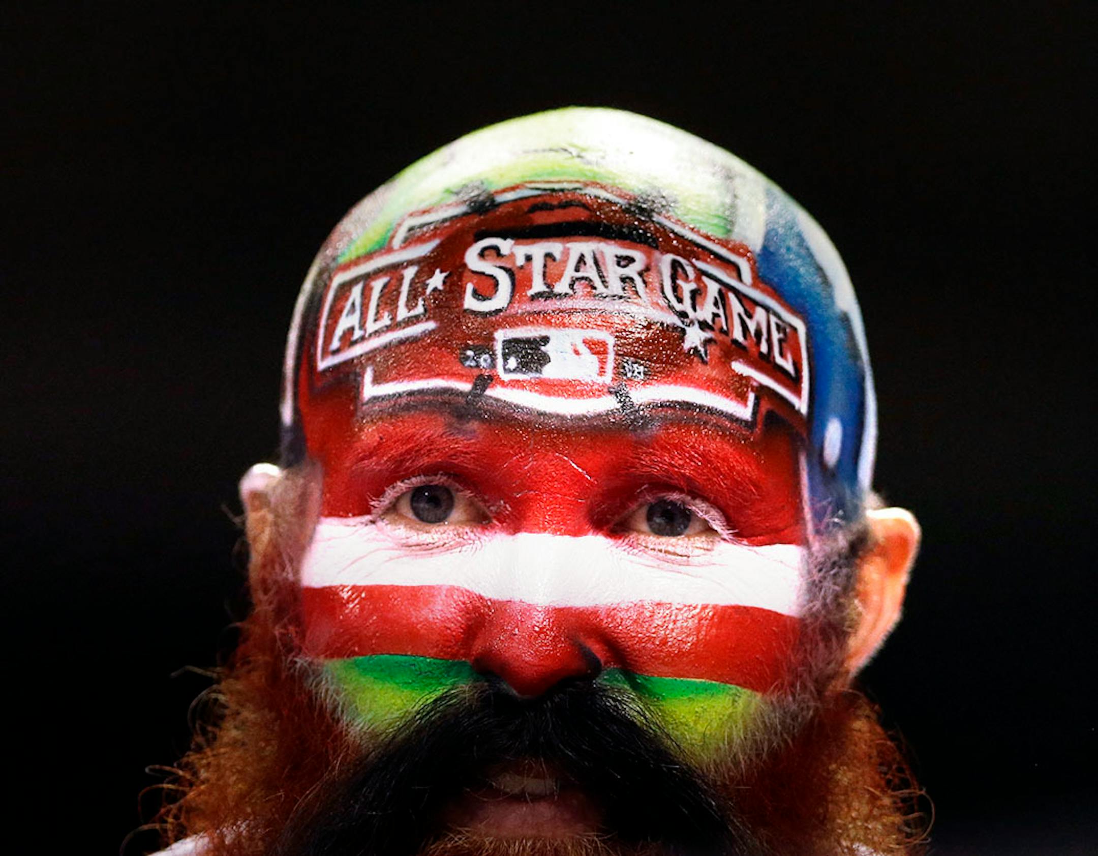 A fan watches from the stands during the fifth inning of the MLB All-Star baseball game, Tuesday, July 14, 2015, in Cincinnati. (AP Photo/Jeff Roberson)
