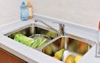 The constant mix of moisture and food in the kitchen sink makes it prone to bacteria like E. coli and salmonella. (Dreamstime)
