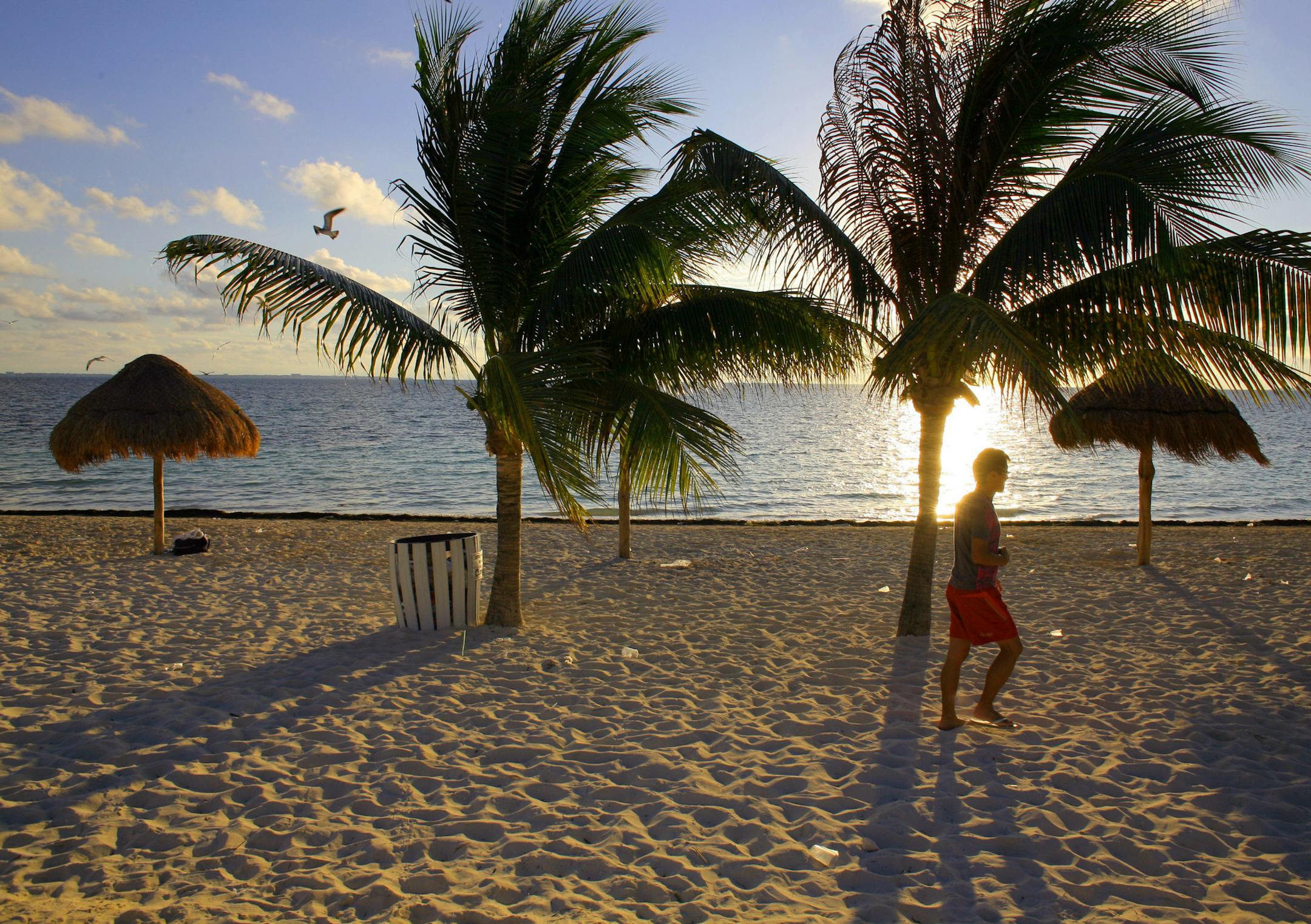 *FILE PHOTO* -- The beach near the Villa Playa Blanca Hotel in Cancun, Mexico in January 2008. While the travel industry is still hurting from the fallout, airlines, rental car companies and hotels have all been tweaking their businesses to ride out the downturn and push rates back up. And some of the efforts are working. Bookings have begun to pick up in cities like New York and Chicago as business travel has begun to stir. That's putting a damper on the deals that travelers have grown to expec