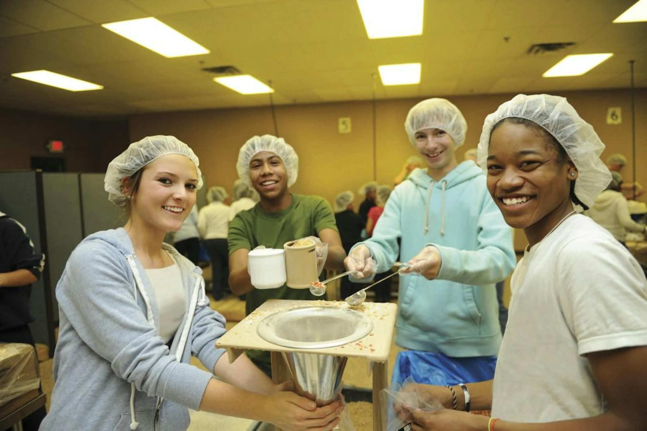 Feed My Starving Children Volunteers pack nutritious meals at Feed My Starving Children's permanent site in Coon Rapids, MN.