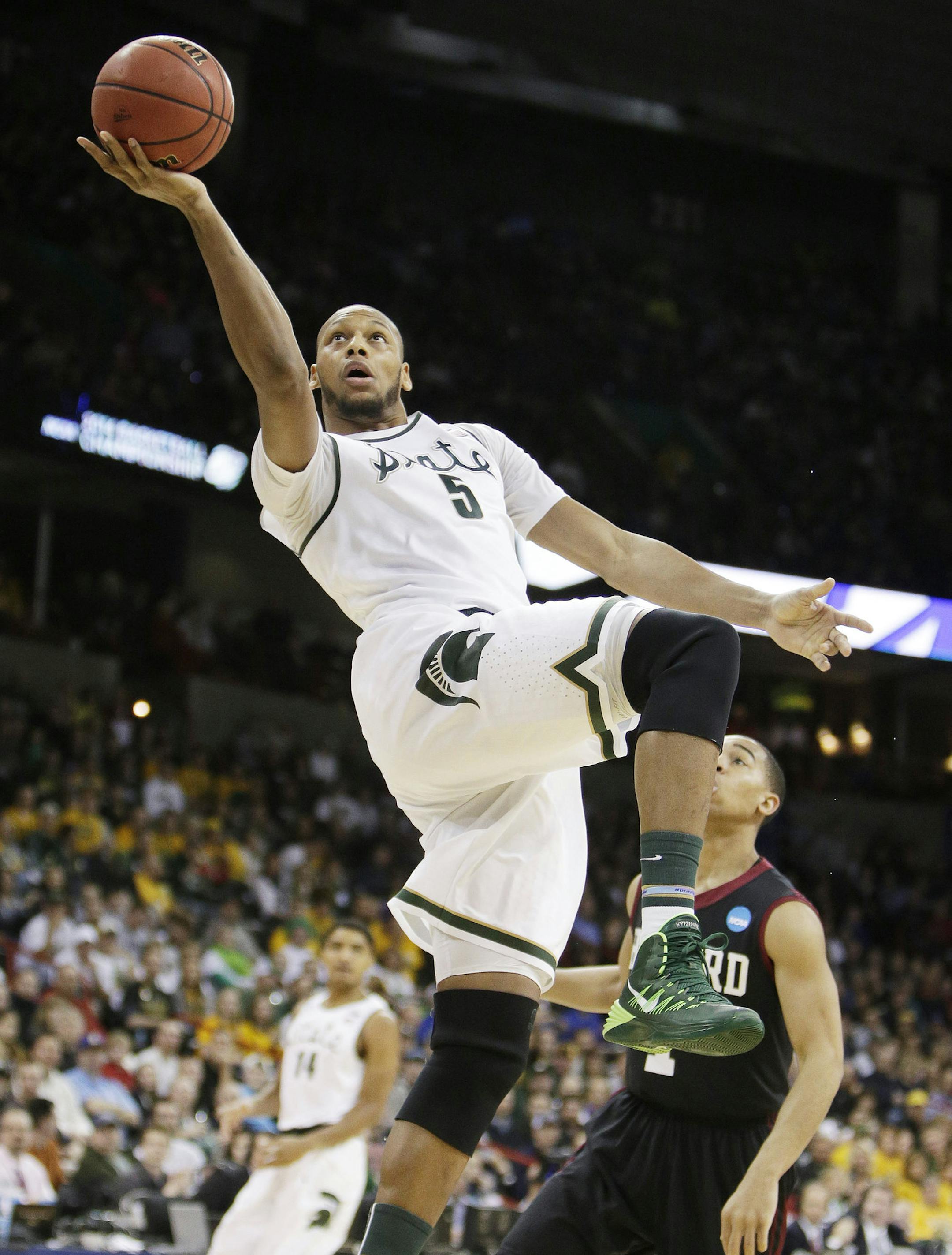 Michigan State’s Adreian Payne (5) shoots a layup in the first half during the third-round game of the NCAA men's college basketball tournament against Harvard in Spokane, Wash., Saturday, March 22, 2014. (AP Photo/Young Kwak)