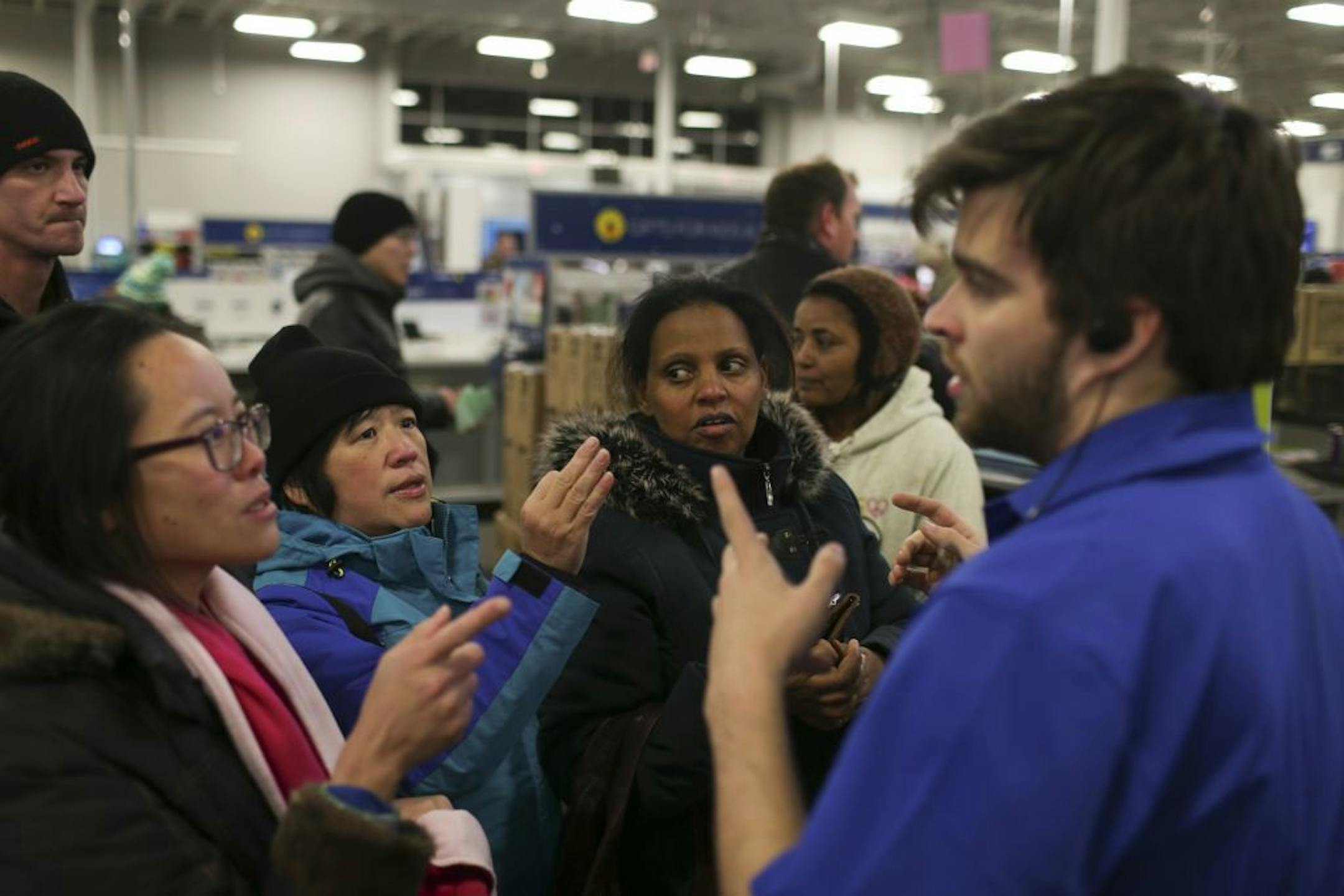 Best Buy employee Josiah Rice took iPad orders from several customers at once shortly after the Roseville store opened Thursday evening.
