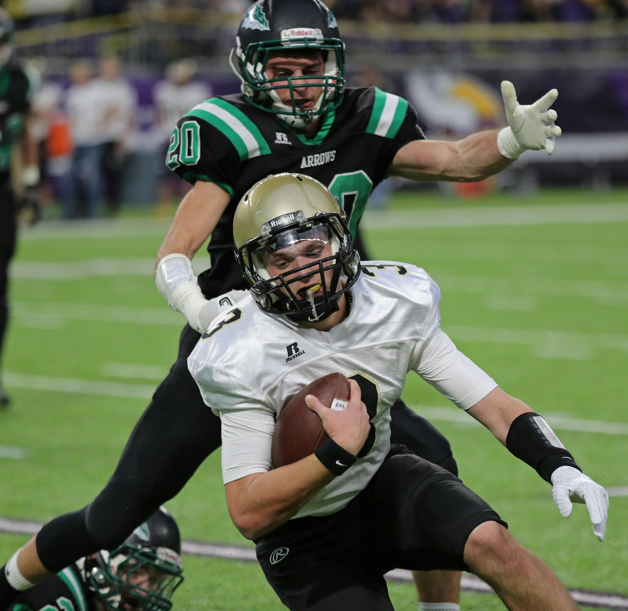 Caledonia quarterback Owen King scrambled away from Pipeston's Tyl Woelber in the first half.
] Shari L. Gross ï shari.gross@startribune.com Caledonia led Pipestone 36-6 in the Class 3A championship football game Friday, Nov. 24, 2017 at U.S. Bank Stadium.