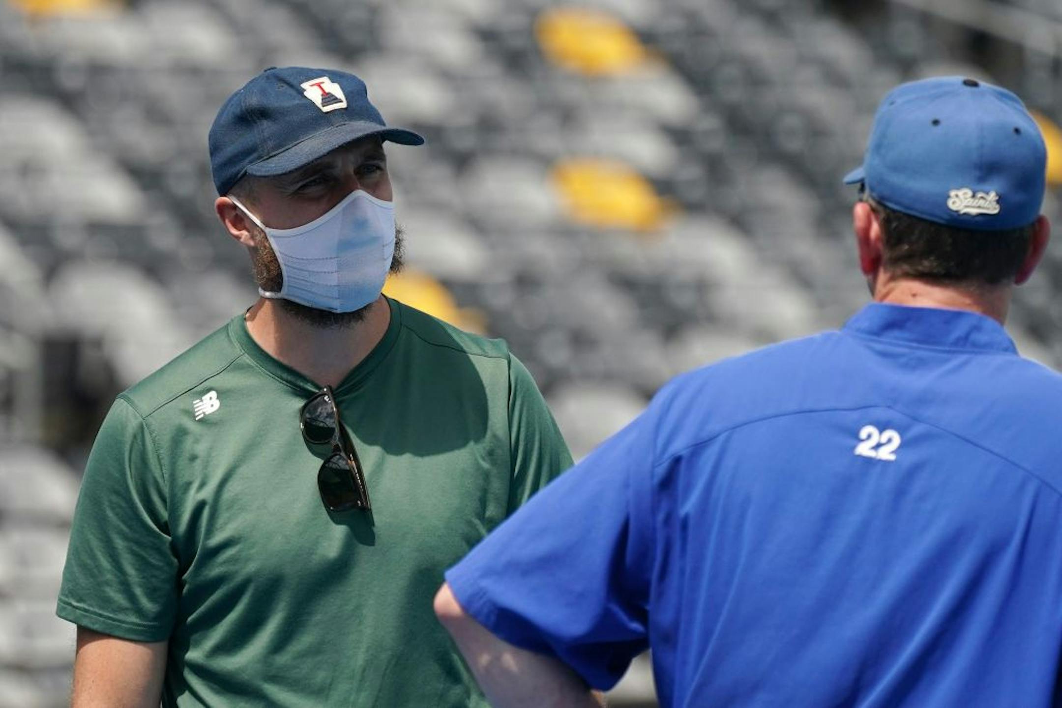 Minnesota Twins manager Rocco Baldelli spoke with Saints manager George Tsamis during a practice at CHS Field. The Saints aren't being allowed to play games there, so they will play home games in Sioux Falls.
