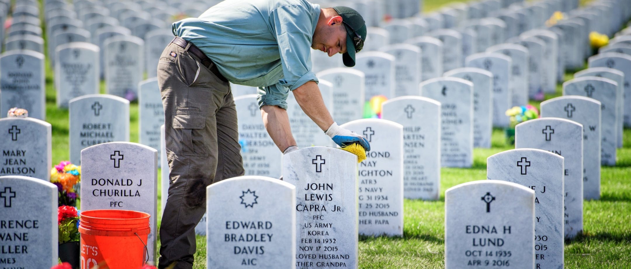 Joe Jandrich carefully hand scrubbed grave markers in a new section of Fort Snelling National Cemetery where fresh sod had just been installed.