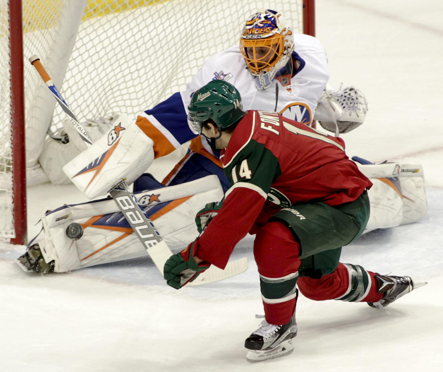 New York Islanders goalie Jaroslav Halak (41), of the Czech Republic, stops a point-blank shot by Minnesota Wild right wing Justin Fontaine (14) during the first period of an NHL hockey game, Tuesday, Feb. 23, 2016, in St. Paul, Minn. (AP Photo/Paul Battaglia)